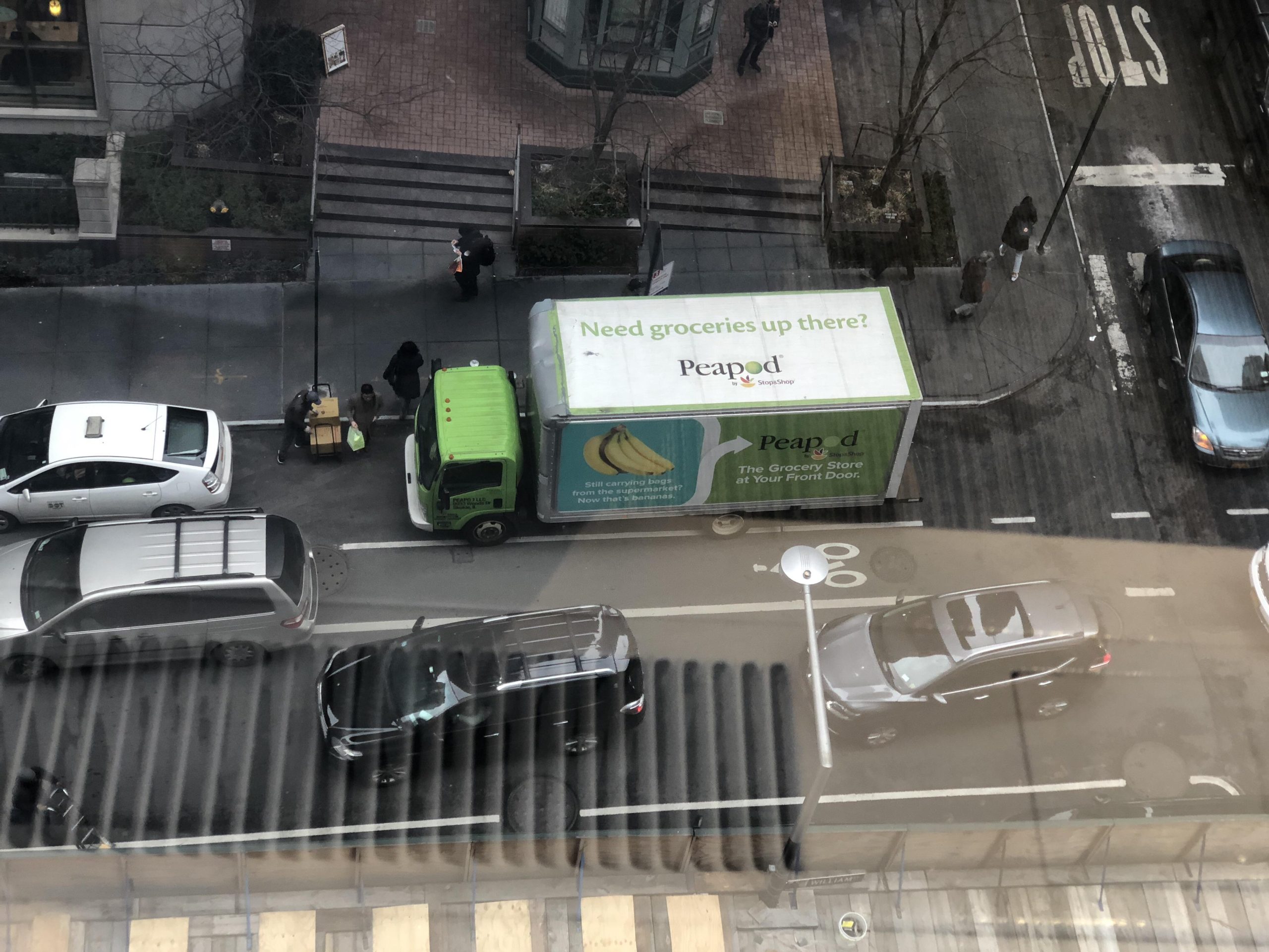 A birds eye view on to the top of a track that has an advert on its roof.