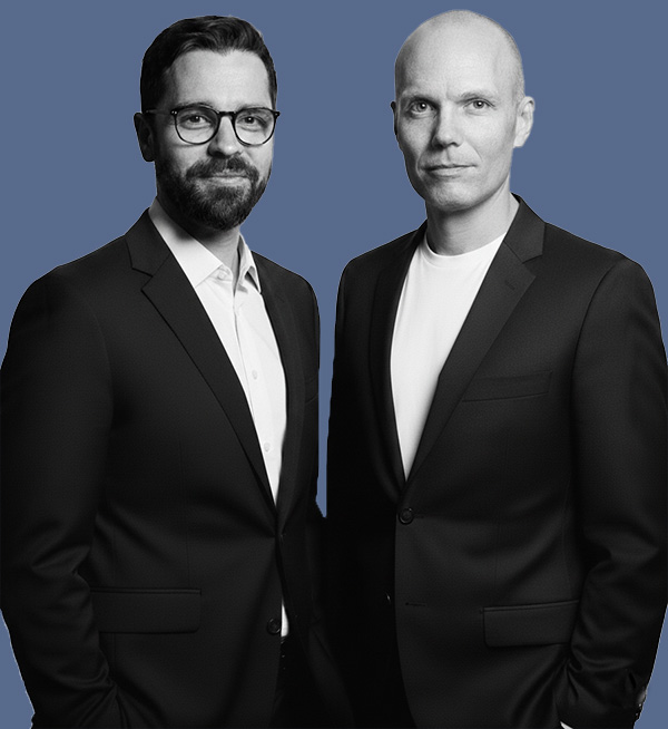 A black and white image of two men wearing suits