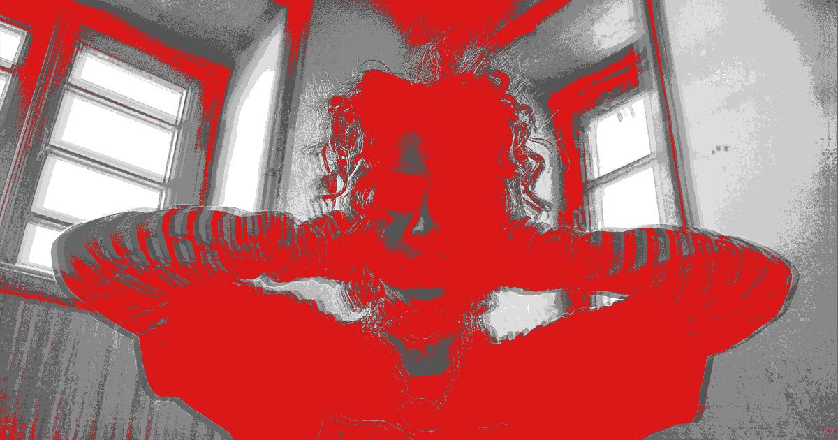 A woman covering her ears to block out noise